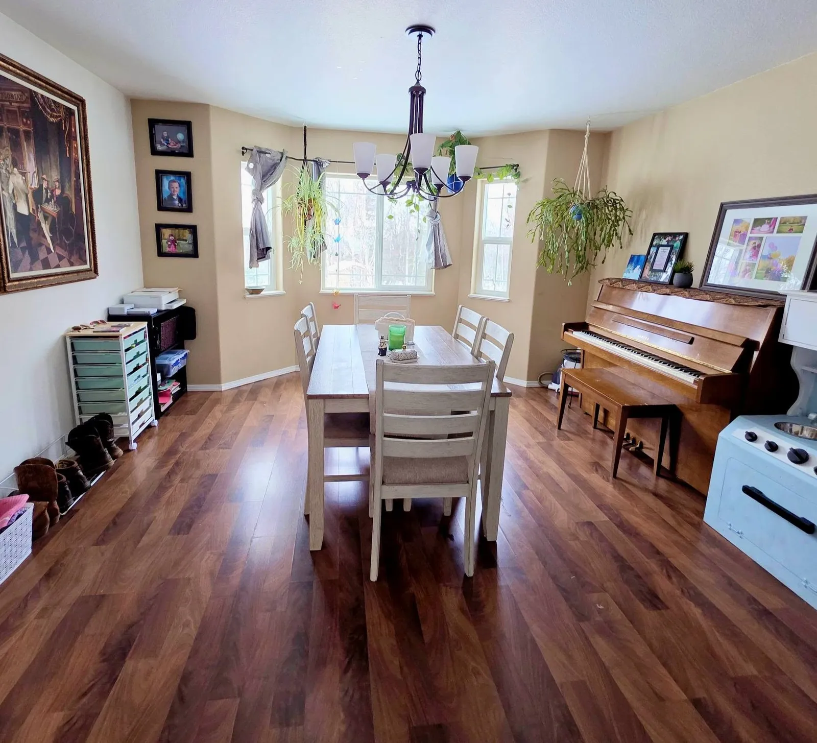 A dining room and piano with gleaming floors after a PureMind deep clean
