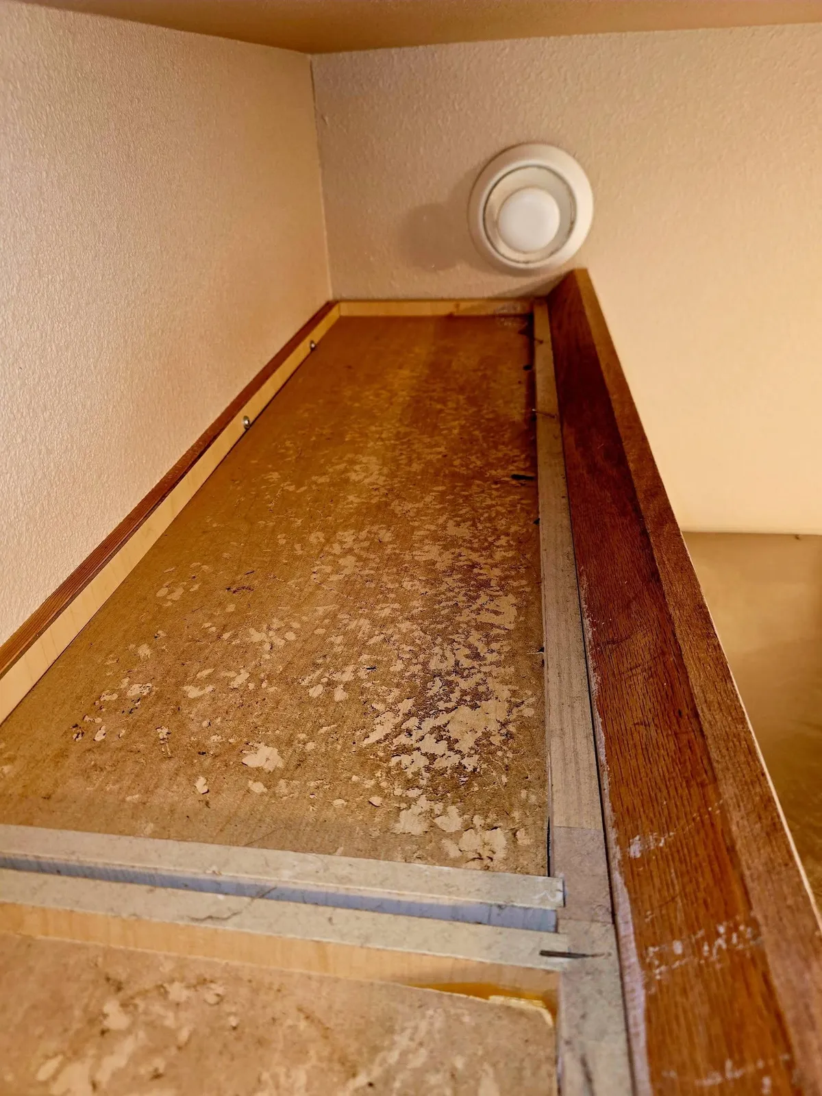 A floor edge covered in grime before move-out cleaning