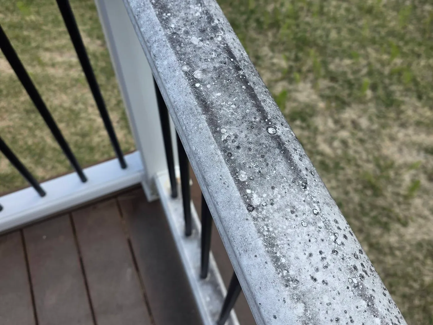 Deck railing before and after cleaning — before