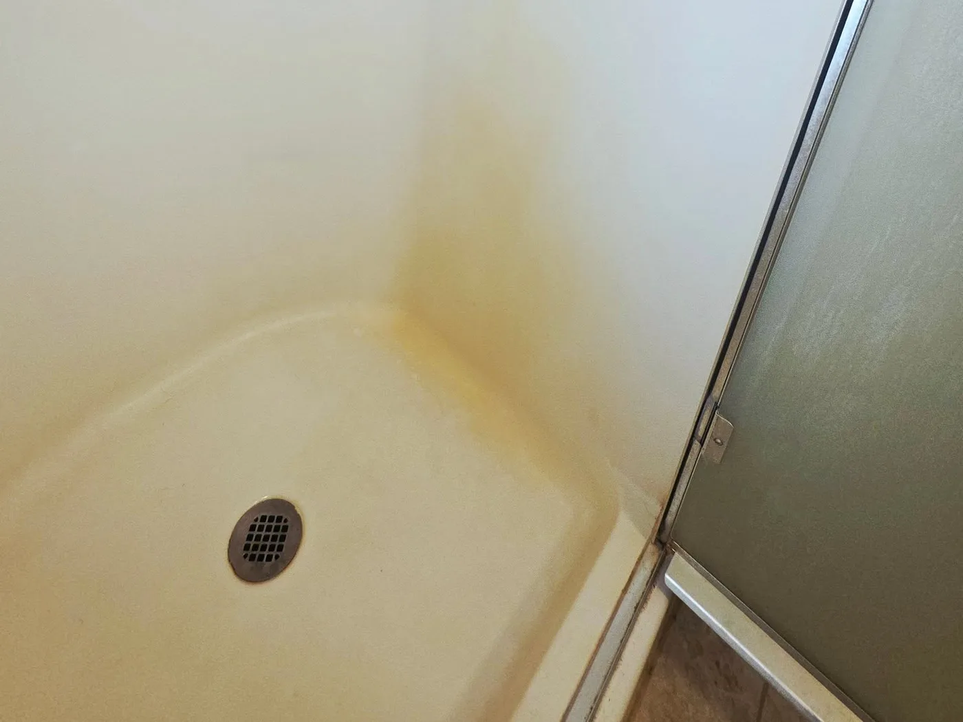 Bathtub before and after cleaning — before